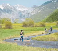  ?? Brett Schreckeng­ost, Telluride Ski Resort ?? Stand-up paddleboar­ding is available in Telluride.