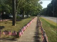  ?? KEVIN MARTIN — THE MORNING JOURNAL ?? Nearly 3,000 small flags are lined outside Avon Lake High School, 175 Avon Belden Road, in memory of the victims of the Sept. 11 terror attacks. The flags are placed every year by members of the school’s Key Club, with assistance from the local Kiwanis group.