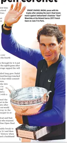  ??  ?? SPAIN’S RAFAEL NADAL poses with his trophy after winning the men’s final tennis match against Switzerlan­d’s Stanislas “Stan” Wawrinka at the Roland Garros 2017 French Open on June 11 in Paris.