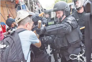  ??  ?? Counter protesters clash with Boston Police outside the Boston Commons and the Boston Free Speech Rally in Boston. — Reuters photo