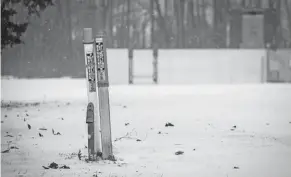  ?? WELLS/PORT HURON TIMES HERALD BRIAN ?? Markers for an Enbridge pipeline stand in the snow along the St. Clair River. Canadians weren’t pleased when Gov. Whitmer said she was shutting down Line 5 that runs through Marysville and under the river to Sarnia in Ontario.