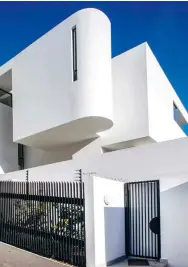  ??  ?? LEFT The school of Tel Aviv Bauhaus informed the design of
this home. OPPOSITE Two Michael Taylor artworks hang above the custom-made server with curved edges and Nero Marquina surface. The bright orange USM cabinet brings
a pop of vivid colour to this space.