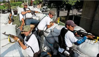  ?? ?? FIGHTING BACK: Anti-cartel volunteers on patrol in Michoacán state, where most of Mexico's avocados are grown