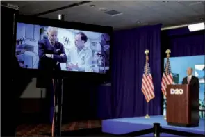  ?? REUTERS ?? An image of former vice-president Joe Biden talking to a cancer researcher is displayed on a screen as Democratic National Committee Chairman Tom Perez stands on stage at the Wisconsin Center in Milwaukee, Wisconsin, on Thursday.