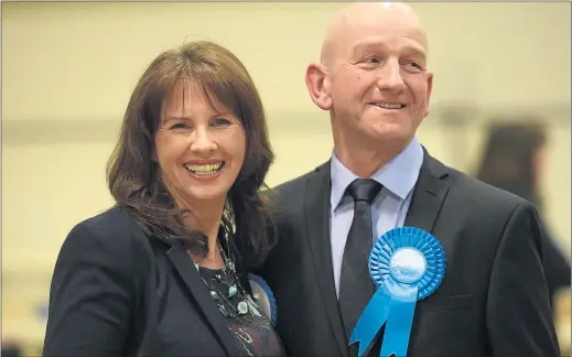  ??  ?? RED TURNS BLUE: Conservati­ve Party candidate Trudy Harrison celebrates with her husband Keith after winning the former Labour seat of Copeland in Whitehaven.