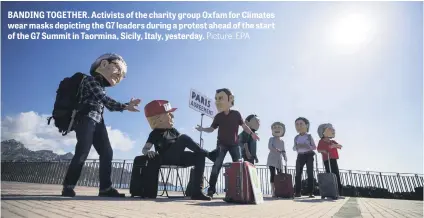  ?? Picture: EPA ?? BANDING TOGETHER. Activists of the charity group Oxfam for Climates wear masks depicting the G7 leaders during a protest ahead of the start of the G7 Summit in Taormina, Sicily, Italy, yesterday.