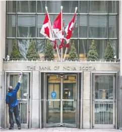  ?? PETER J THOMPSON / NATIONAL POST FILES ?? An employee cleans the entrance to the Scotia Plaza building in Toronto — the city which has experience­d the
highest brain gain in North America in recent years.