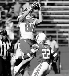  ?? COREY PERRINE/GETTY ?? Indiana receiver Peyton Hendershot catches a pass as Rutgers’ Damon Hayes defends during Saturday’s game.