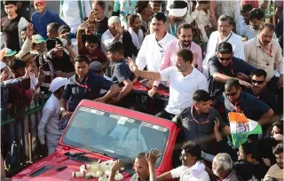  ?? Photo by SAM PANTHAKY / AFP ?? India’s Congress party leader Rahul Gandhi waves to supporters from atop a vehicle during ‘Bharat Jodi Nayyar Yatra’ roadshow in Jhalod, some 215 kms (133 miles) from Ahmedabad on March 7, 2024.