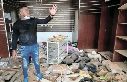  ?? /ANTONIO MUCHAVE ?? Modishane Tema inside the familly business called The Lab at Chris Hani Mall, one of businesses looted during protests in Vosloorus, Ekurhuleni.