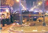  ?? GERALD HERBERT/ AP ?? Police stand next to a pickup truck that slammed into a crowd and other vehicles, causing multiple injuries in New Orleans on Saturday.