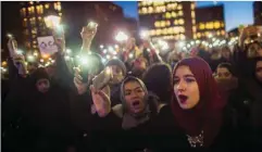  ?? — AP ?? NEW YORK: In this Jan 25, 2017 photo, Muslim women shout slogans during a rally against President Donald Trump’s order cracking down on immigrants living in the US at Washington Square Park.