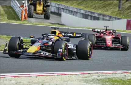  ?? HIRO KOMAE/AP ?? Red Bull driver Max Verstappen was back in his accustomed spot — at the front — at the Japanese Grand Prix. He won by 12.5 seconds over teammate Sergio Perez. In the previous race, a problem with his brakes led to Verstappen being sidelined on lap 4.
