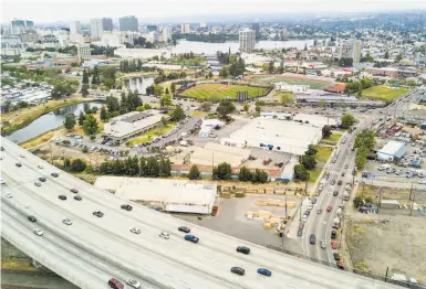  ?? Noah Berger / Special to The Chronicle ?? The proposed Oakland A’s stadium site is near Interstate 880, but getting there would involve city streets rather than vast swaths of parking lot. Team and city officials foresee fans mostly taking transit to games.