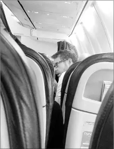  ??  ?? An expatriate passenger travelling on a flight from the Saudi capital Riyadh to the Red Sea city of Jeddah.