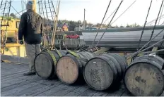  ?? IRONWORKS DISTILLERY/THE CANADIAN PRESS ?? Barrels of rum from Ironworks Distillery rest before being loaded on a tall ship in this undated handout photo. Over the next 15 months, four barrels of rum from Ironworks Distillery in Lunenburg, N.S., will travel in the cargo hold of the three-masted...