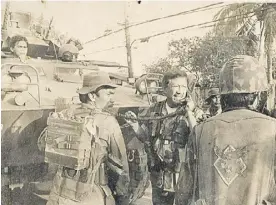  ?? ?? general cunanan outside the main gate of camp aguinaldo commanding troops and armored units and orchestrat­ing the counter-offensive against coup plotters.