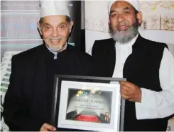  ??  ?? IMAM Yaseen Harriss, left, received an award from The Voice of The Cape Radio for his many years of sacrifice for the upliftment of the community in 2015.