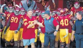  ?? Robert Gauthier
Los Angeles Times ?? WILL FERRELL and Coach Steve Sarkisian lead USC out of the Coliseum tunnel before the Stanford game. It didn’t go over well with every Trojans fan.