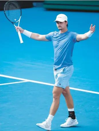  ?? DANIEL POCKETT/GETTY ?? J.J. Wolf celebrates match point during his match against Michael Mmoh at the Australian Open on Saturday at Melbourne Park in Melbourne, Australia.