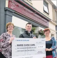  ?? Photo: Abrightsid­e Photograph­y. ?? Office manager Beth MacBeath with senior funeral director Jamie Manson, present the cheque to Joan MacKintosh of Marie Curie.