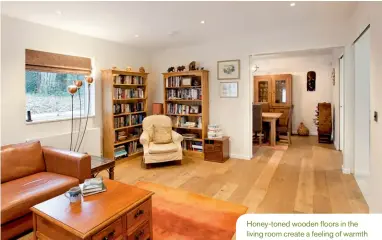  ??  ?? Honey-toned wooden floors in the living room create a feeling of warmth