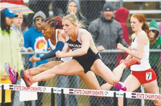  ?? Hyoung Chang, The Denver Post ?? Rock Canyon’s Emily Sloan , center, heads for the Class 5A state title in the 100-meter hurdles Saturday at Jeffco Stadium.