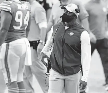  ?? JOHN MCCALL/SUN SENTINEL ?? Dolphins coach Brian Flores looks up at the scoreboard as his team takes on the Chiefs at Hard Rock Stadium on Dec. 13.