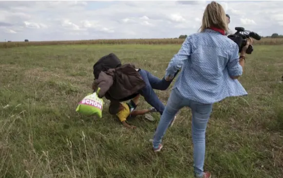  ?? MARKO DJURICA/REUTERS ?? Video of this moment — Hungarian camerawoma­n Petra Laszlo tripping Syrian refugee Osama Mohsen and his 7-year-old son, Said — would dramatical­ly change all their lives.