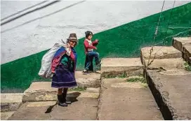  ?? Federico Rios Escobar / New York Times ?? A woman walks with her niece in Silvia, Colombia.