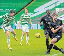  ??  ?? Mikey Johnston tries to break down the Livi defence