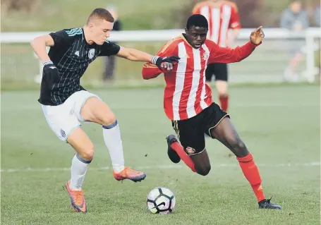  ??  ?? Goalscorer Ben Kimpioka battles for Sunderland Under-18s against West Brom in yesterday’s Academy of Light clash. Picture by Tim Richardson