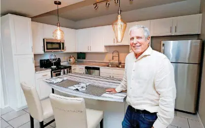  ?? [PHOTOS BY NATE BILLINGS, THE OKLAHOMAN] ?? Tulsa developer Ed Leinbach shows the open-concept kitchen of an apartment in Leinbach Co.’s new Crown at Lone Oak Apartments, north of NW 150 and west of Portland Avenue.