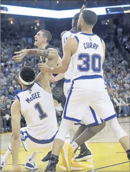  ?? JEFF CHIU — THE ASSOCIATED PRESS ?? Warriors center JaVale McGee falls back into Stephen Curry on Friday night, injuring the All-Star guard’s left knee.