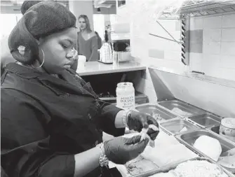  ?? ALGERINA PERNA/ BALTIMORE SUN PHOTOS ?? Lynell Revell, 16, above, is part of the front-ofhouse service at the pop-up restaurant Aromatic at R. House. Aniya Lowther, 17, at left, preps a croque madame sandwich. The restaurant is part of the National Academy Foundation School, which focuses on...