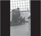  ?? MICHAEL MCDUNNAH /AP ?? An image from cellphone video shows Chicago police officers trying to apprehend Ariel Roman inside a downtown Chicago train station on Friday. After a struggle with police, Roman was shot as he fled up the escalator with the officers in pursuit.