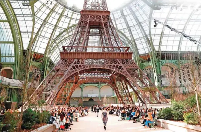  ??  ?? A picture taken on July 4, 2017 shows a replica of the Eiffel Tower as part of the set for the Chanel 2017-2018 fall/winter Haute Couture collection at the Grand Palais in Paris. — AFP photos