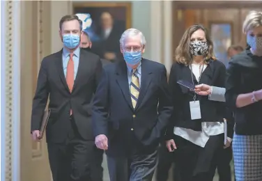  ?? J. Scott Applewhite / Associated Press ?? Senate Minority Leader Mitch McConnell, RKy. (center), voted not guilty in the impeachmen­t trial, but said former President Donald Trump was “practicall­y and morally responsibl­e” for the insurrecti­on.