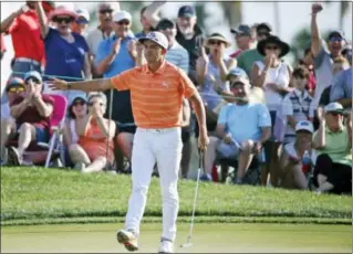  ?? WILFREDO LEE — THE ASSOCIATED PRESS ?? Fans cheer for Rickie Fowler after his putt on the 12th hole during the final round of the Honda Classic, Sunday in Palm Beach Gardens, Fla.