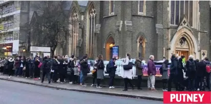  ??  ?? Wrapped up: There were long waits to cast votes in Putney PUTNEY