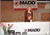  ?? RON SEYMOUR/The Daily Courier ?? A candle is lit on behalf of the victims of impaired drivers at a service Sunday at Kelowna’s Laurel building. Lighting the candle was Eva Gainor, who lost her husband and a son to a drunk driver in 2000.