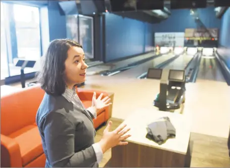  ?? Tyler Sizemore / Hearst Connecticu­t Media ?? Senior Manager Megan Salisbury chats by four of the 12 bowling lanes at the new Pinstripes bistro, bowling, and bocce lounge at the SoNo Collection shopping center in South Norwalk on Wednesday.