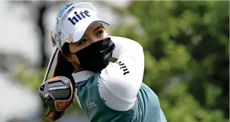  ?? -- AP ?? RETURN TO ACTION: Wearing a face mask, Choi Ye-rim of South Korea watches her tee shot on the first hole during the first round of the KLPGA Championsh­ip at the Lakewood Country Club in Yangju, South Korea, on Thursday.