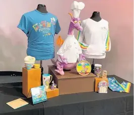  ?? DEWAYNE BEVIL/ORLANDO SENTINEL ?? Rainbow-tinged Figment merchandis­e includes leggings (far right), festival shirts, kitchen goods and more.