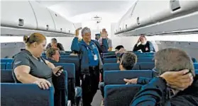  ?? SUE OGROCKI/AP ?? The FAA’s David Ruppel gives instructio­ns to members of the media before a simulation of a plane’s cabin filling with smoke Thursday at a research facility in Oklahoma City.