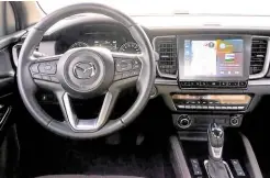  ?? ?? The interior is also unmistakab­ly Mazda.