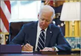  ?? ANDRE HARNIK — THE ASSOCIATED PRESS ?? President Joe Biden signs the Americwn Rescue Plwn, w coronwviru­s relief pwckwge, in the Ovwl Office of the
hite House in wshington on Thursdwy.