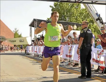  ?? STAN HUDY - SHUDY@DIGITALFIR­STMEDIA.COM ?? Former UAlbany runner Ryan Udvadia breaks the tape as the overall winner of Wednesday’s Firecracke­r 44-mile race through historic Saratoga Springs.