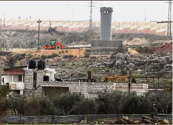  ??  ?? Eye of the storm: The house of the Jumaa family, which has become encircled by Israel’s controvers­ial separation barrier, north of Ramallah. — AFP