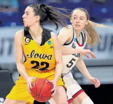  ?? Carmen Mandato, Getty Images ?? UConn’s Paige Bueckers (5) defends Iowa’s Caitlin Clark during Saturday’s game in San Antonio, Texas.